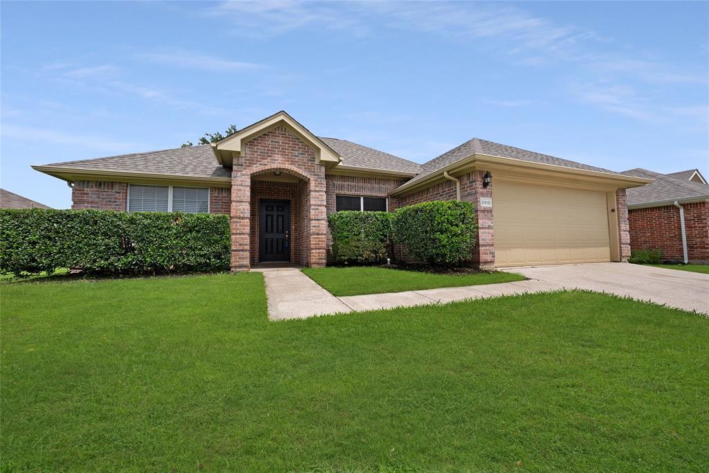 2910 Chisholm Trail Corinth, TX 76210 - Photo 1 of 30 a front view of a house with a yard and garage