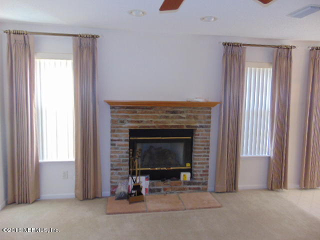 1115 Copper Field Circle Macclenny, FL 32063 - Photo 13 of 40 a living room with furniture and a fireplace