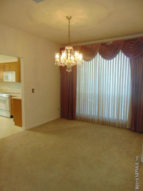 1115 Copper Field Circle Macclenny, FL 32063 - Photo 14 of 40 a view of a chandelier in an empty room with a chandelier fan