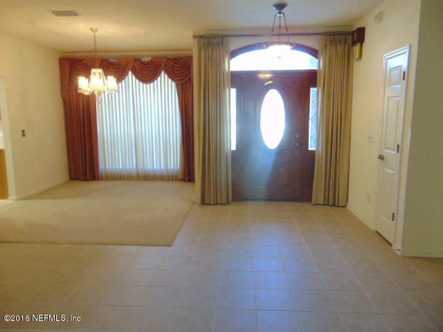 1115 Copper Field Circle Macclenny, FL 32063 - Photo 15 of 40 a view of empty room with chandelier fan and windows