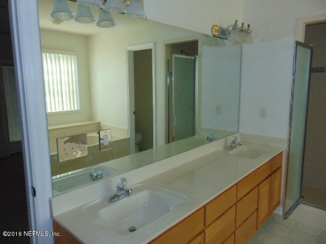 1115 Copper Field Circle Macclenny, FL 32063 - Photo 23 of 40 a bathroom with a sink and a mirror