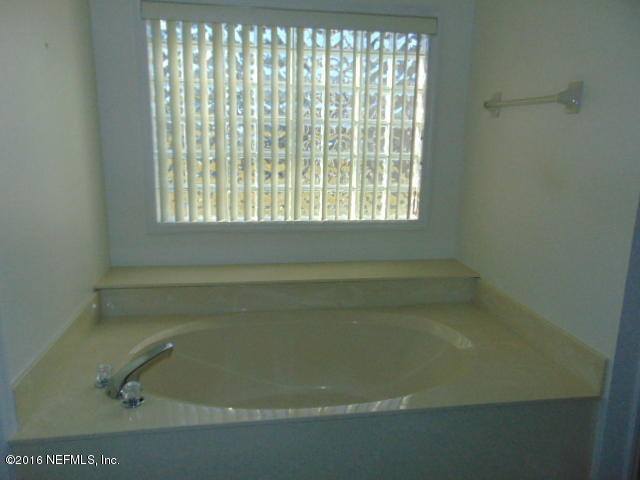 1115 Copper Field Circle Macclenny, FL 32063 - Photo 24 of 40 a close up of a bathtub in a bathroom