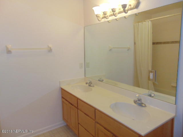 1115 Copper Field Circle Macclenny, FL 32063 - Photo 27 of 40 a bathroom with a sink and mirror