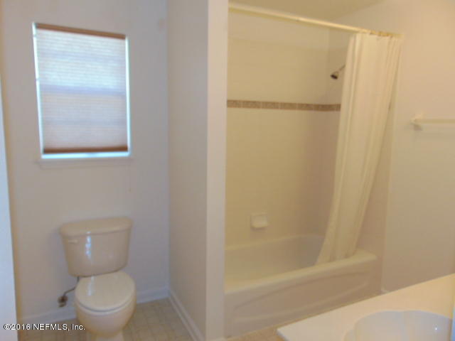 1115 Copper Field Circle Macclenny, FL 32063 - Photo 28 of 40 a bathroom with a toilet and a shower