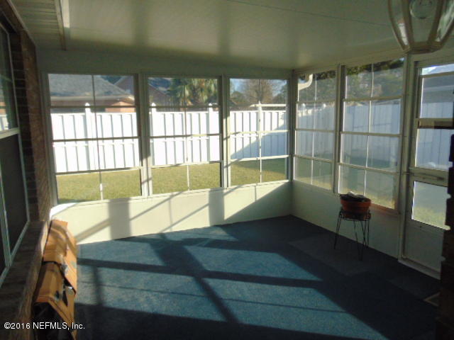 1115 Copper Field Circle Macclenny, FL 32063 - Photo 30 of 40 a living room with furniture and a floor to ceiling window