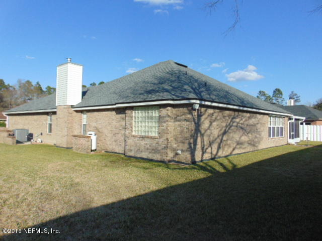 1115 Copper Field Circle Macclenny, FL 32063 - Photo 34 of 40 a view of a house with backyard and trees