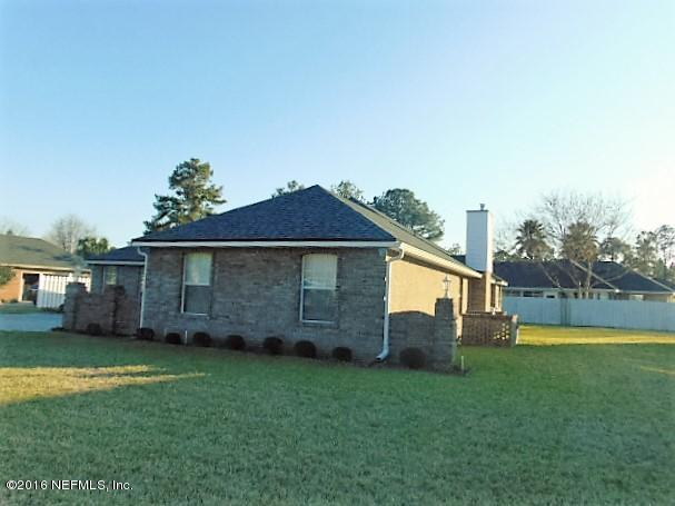 1115 Copper Field Circle Macclenny, FL 32063 - Photo 38 of 40 a view of a backyard with a garden and plants