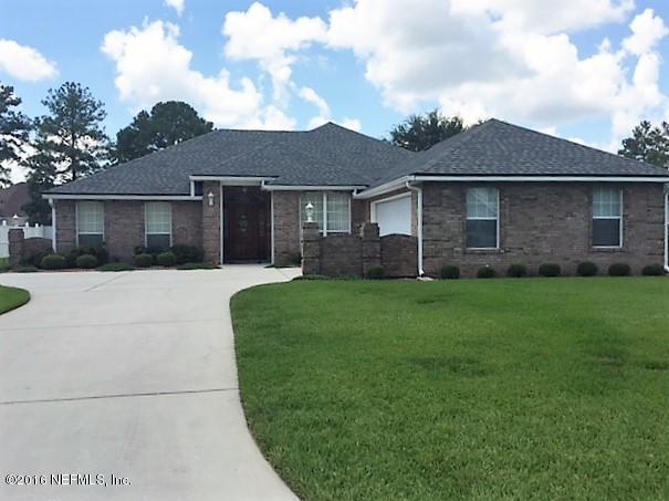 1115 Copper Field Circle Macclenny, FL 32063 - Photo 39 of 40 a front view of a house with a yard and garage