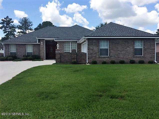 1115 Copper Field Circle Macclenny, FL 32063 - Photo 40 of 40 a front view of a house with a yard and trees
