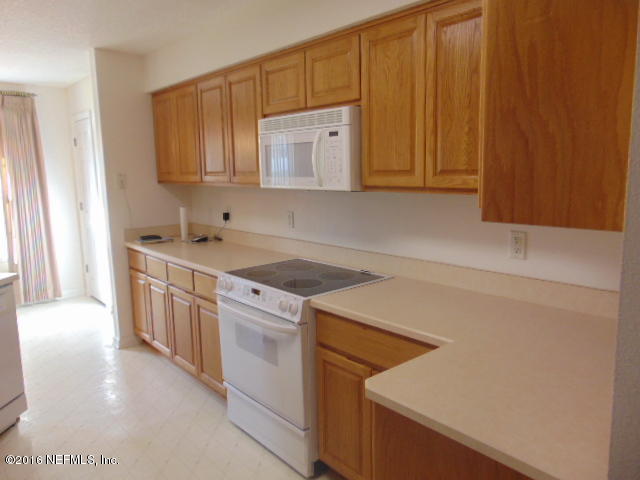 1115 Copper Field Circle Macclenny, FL 32063 - Photo 5 of 40 a kitchen that has a sink and a stove in it