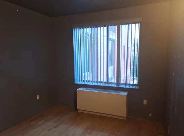 wooden floor and window in an empty room