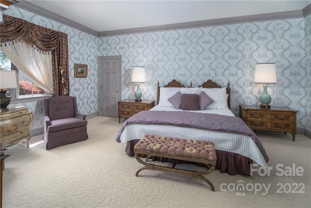 3394 Sandy Ford Road Newton, NC 28658 - Photo 16 of 43 a bedroom with a bed couch and a large window