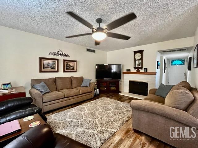 Undisclosed Address Bakersfield, CA 93306 - Photo 11 of 25 a living room with furniture a fireplace and a flat screen tv