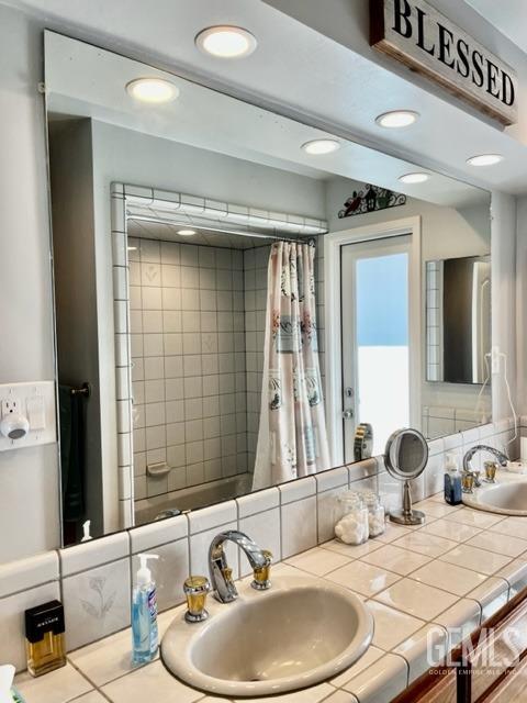Undisclosed Address Bakersfield, CA 93306 - Photo 15 of 25 a bathroom with a sink and a mirror