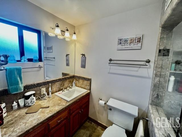 Undisclosed Address Bakersfield, CA 93306 - Photo 20 of 25 a bathroom with a granite countertop sink mirror vanity and toilet