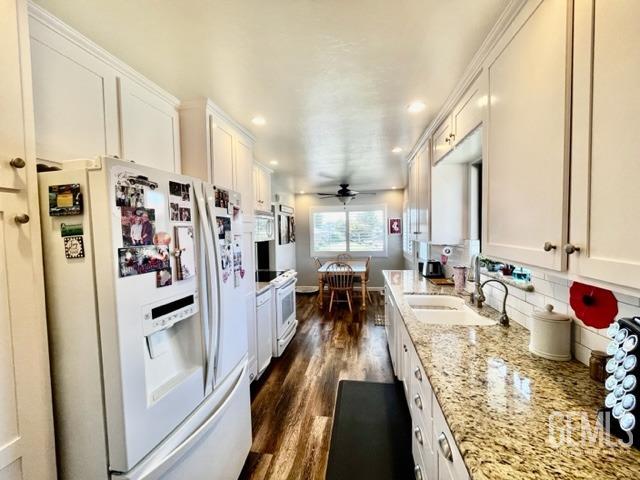 Undisclosed Address Bakersfield, CA 93306 - Photo 8 of 25 a kitchen with stainless steel appliances a refrigerator a sink a stove and white cabinets