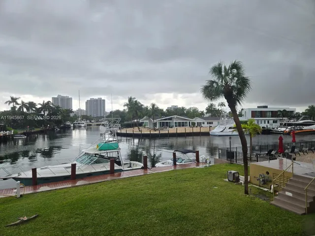 a view of a lake with a garden and a table