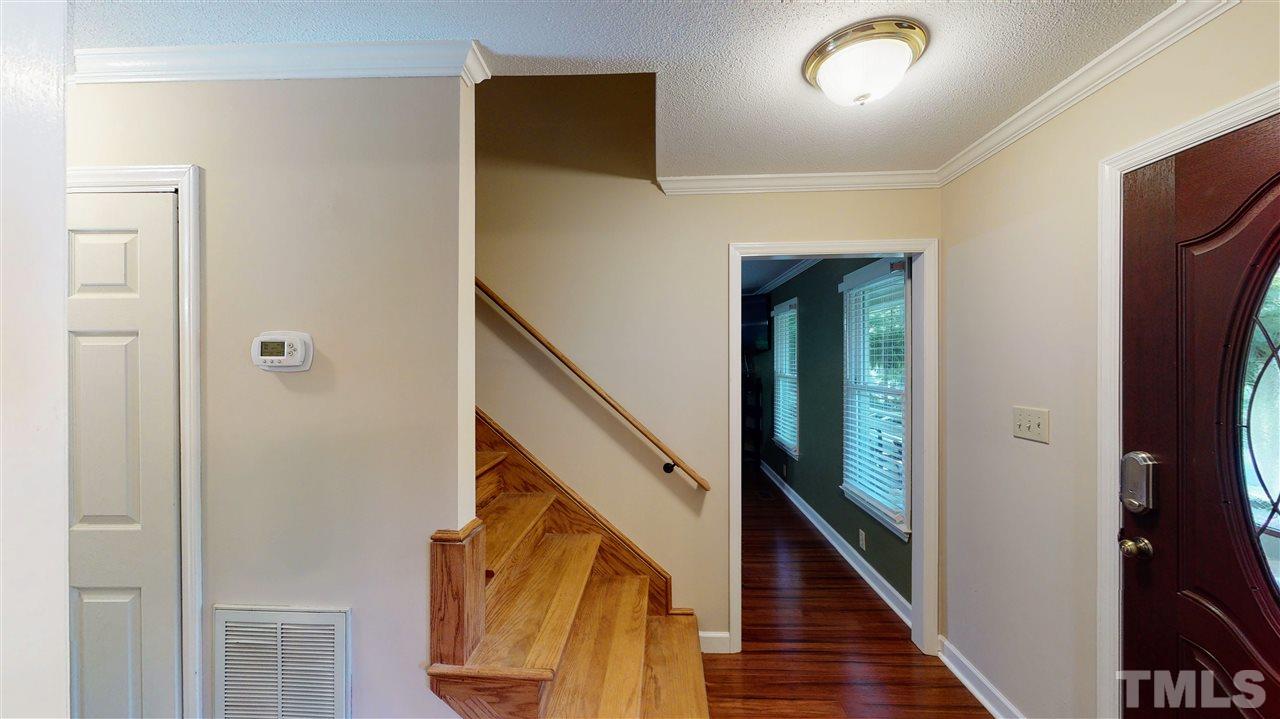 123 Abercrombie Road Wake Forest, NC 27587 - Photo 14 of 27 a view of a hallway with wooden floor and staircase