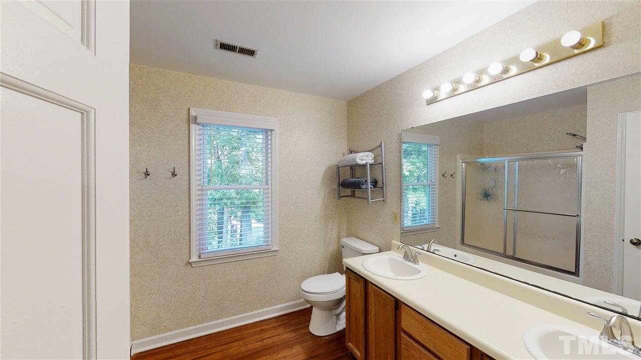 123 Abercrombie Road Wake Forest, NC 27587 - Photo 19 of 27 a bathroom with a toilet sink and mirror