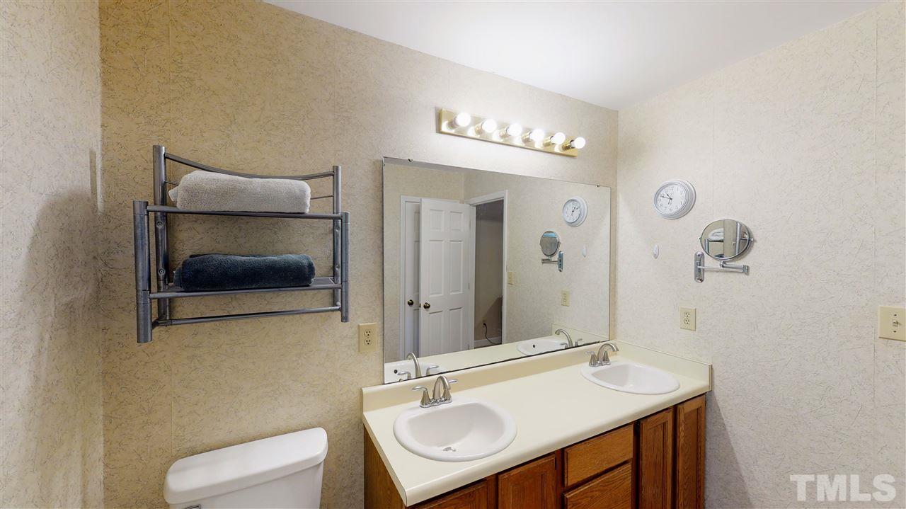 123 Abercrombie Road Wake Forest, NC 27587 - Photo 21 of 27 a bathroom with a sink and a mirror