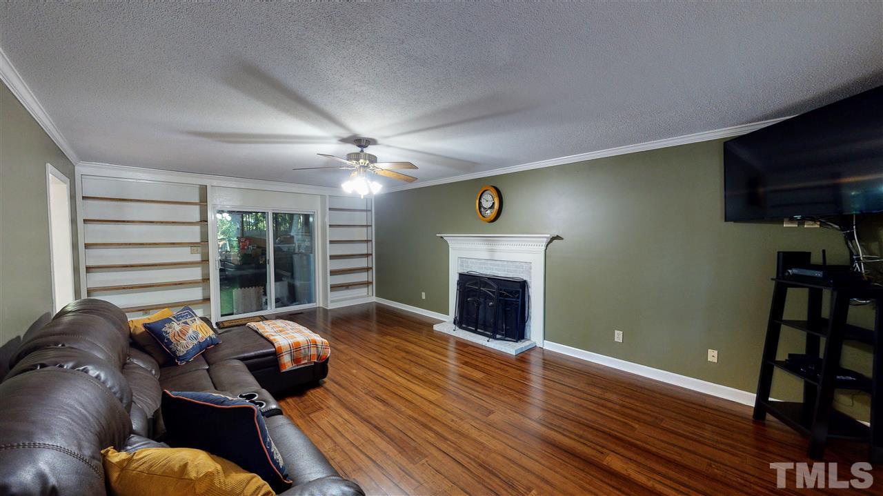 123 Abercrombie Road Wake Forest, NC 27587 - Photo 7 of 27 a living room with furniture and a fireplace