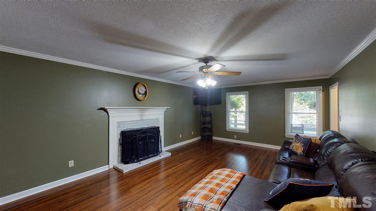 123 Abercrombie Road Wake Forest, NC 27587 - Photo 8 of 27 a living room with furniture and a fireplace