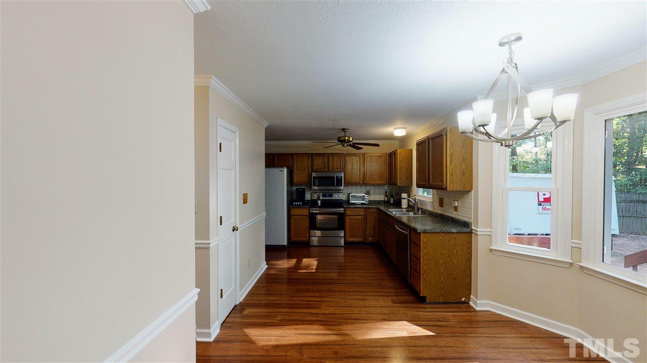 123 Abercrombie Road Wake Forest, NC 27587 - Photo 9 of 27 a large kitchen with a counter space a sink and stainless steel appliances