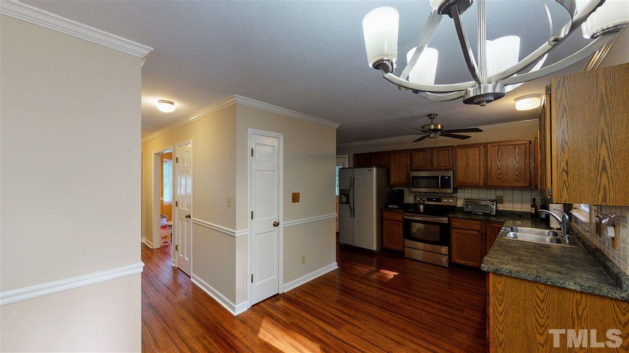 123 Abercrombie Road Wake Forest, NC 27587 - Photo 10 of 27 a kitchen with stainless steel appliances granite countertop a sink a stove and a refrigerator