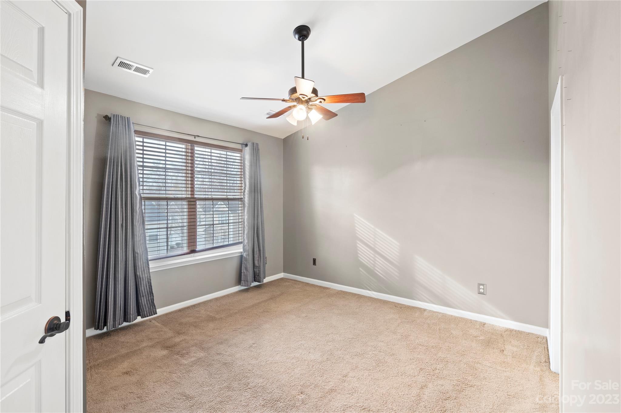 1103 Sienna Sand Way Fort Mill, SC 29708 - Photo 12 of 26 an empty room with windows and fan