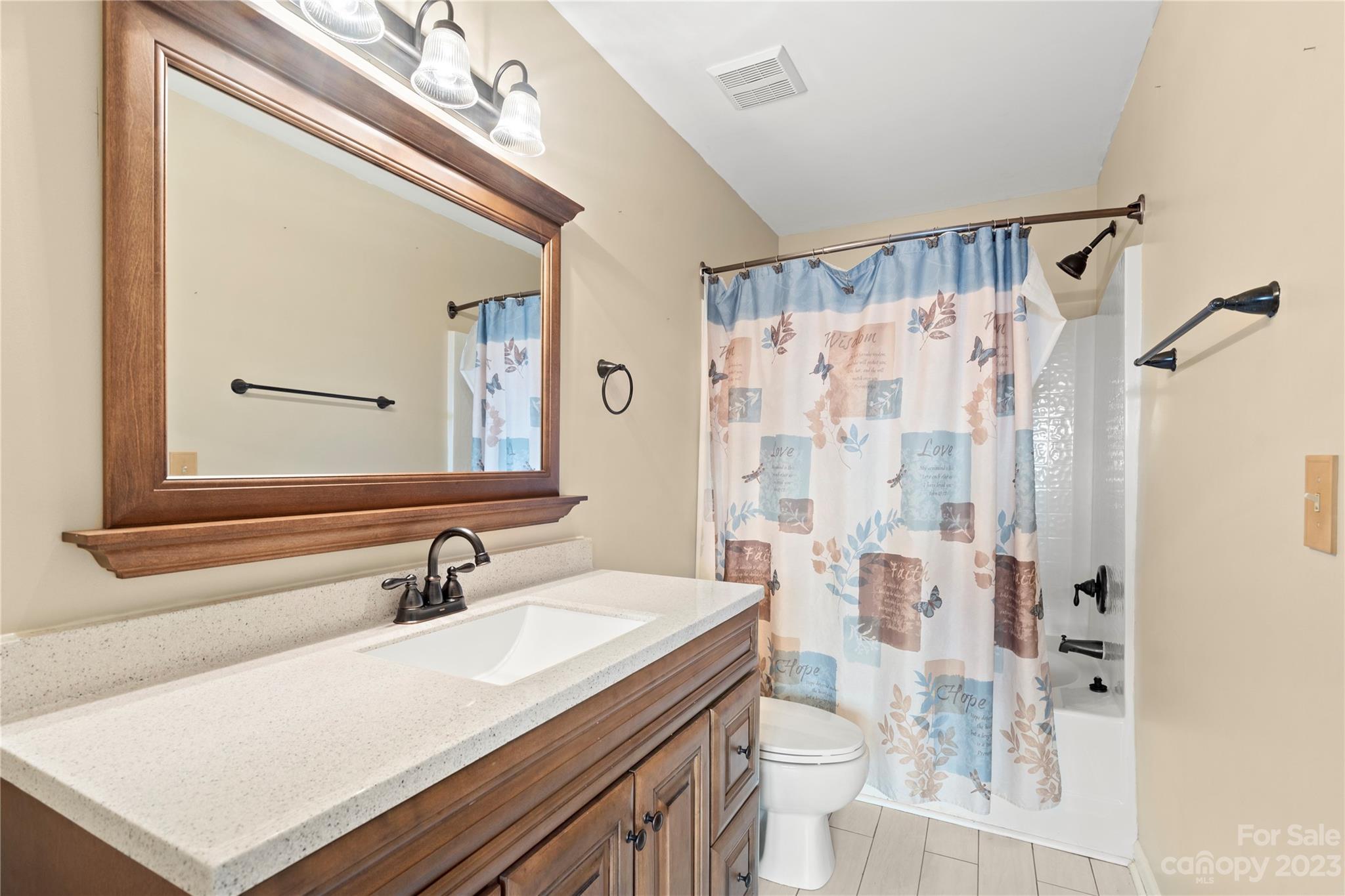 1103 Sienna Sand Way Fort Mill, SC 29708 - Photo 15 of 26 a bathroom with a sink a toilet a mirror and shower