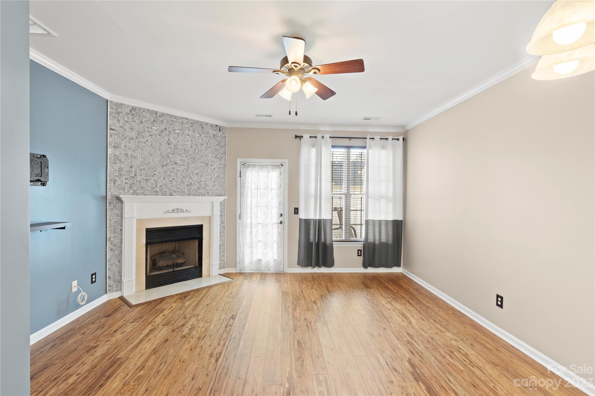 1103 Sienna Sand Way Fort Mill, SC 29708 - Photo 3 of 26 an empty room with wooden floor fireplace and windows