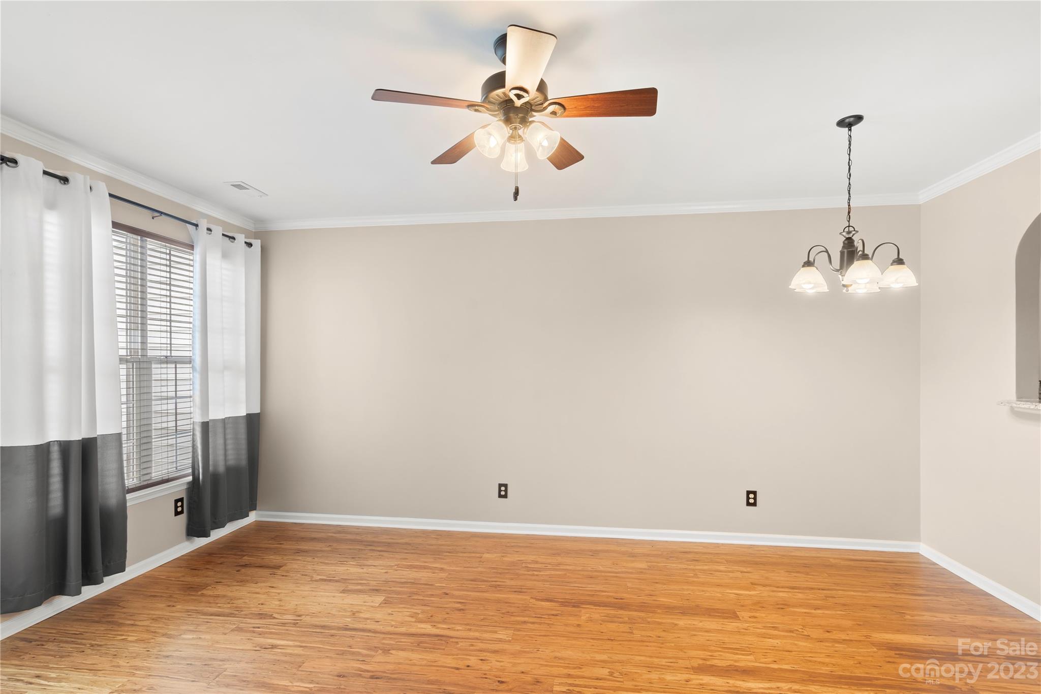 1103 Sienna Sand Way Fort Mill, SC 29708 - Photo 6 of 26 a view of a room with window a ceiling fan and wooden floor