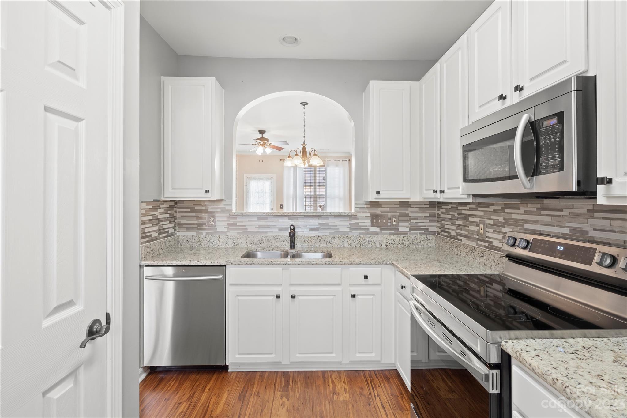 1103 Sienna Sand Way Fort Mill, SC 29708 - Photo 7 of 26 a kitchen with stainless steel appliances granite countertop a stove a sink and a microwave