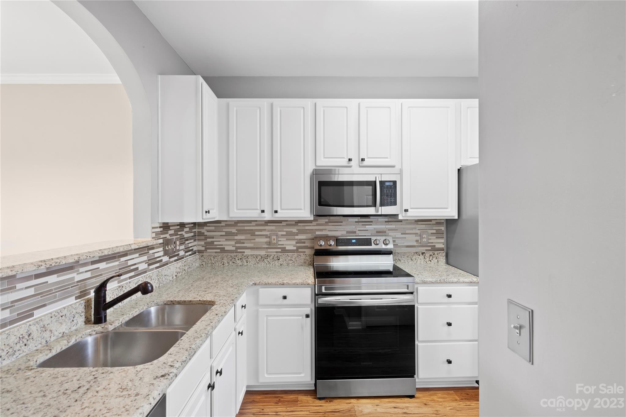 1103 Sienna Sand Way Fort Mill, SC 29708 - Photo 9 of 26 a kitchen with stainless steel appliances a sink stove and cabinets