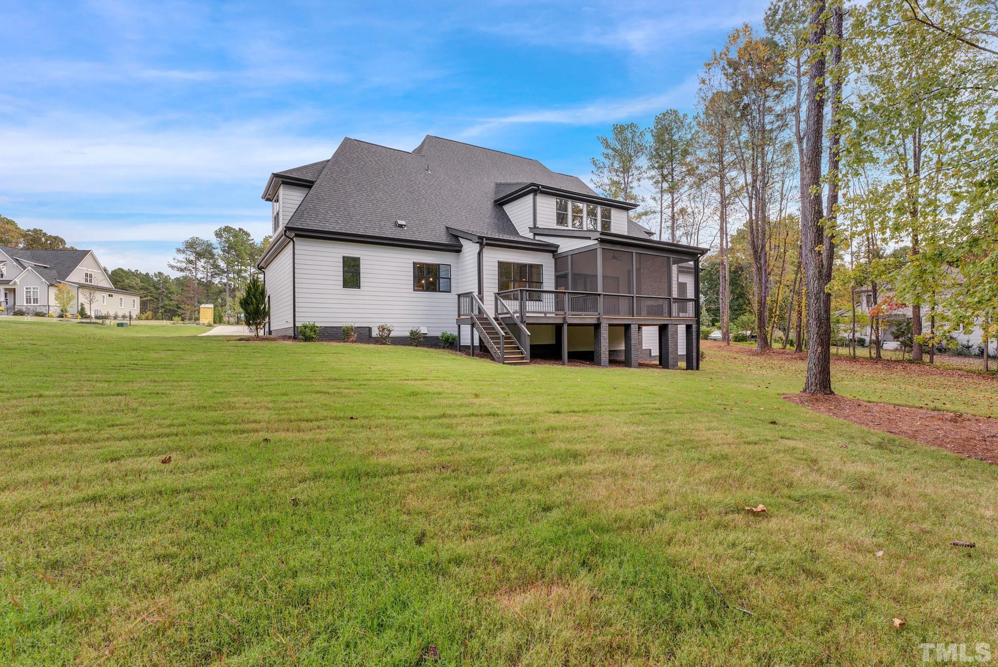10325 Grafton Road Raleigh, NC 27615 - Photo 54 of 58 a view of a house with a big yard and large trees