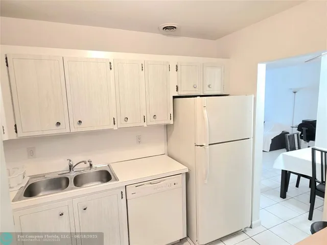 a kitchen with cabinets and white appliances