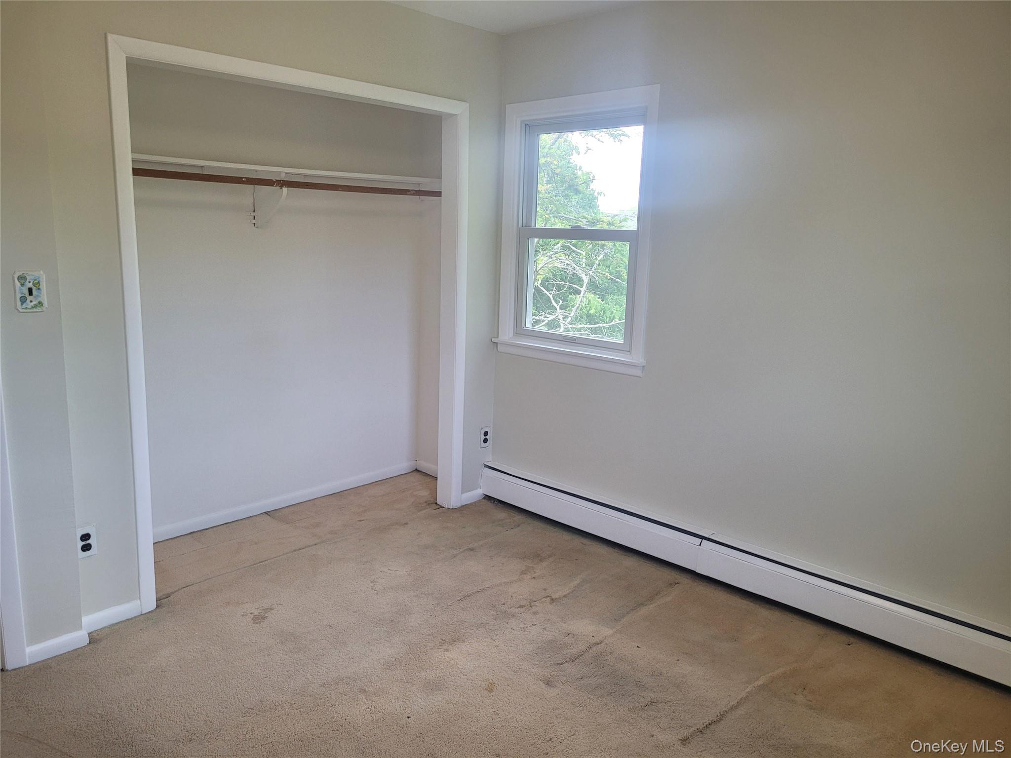 8 Cornell Road East Patchogue, NY 11772 - Photo 18 of 18 an empty room with a window
