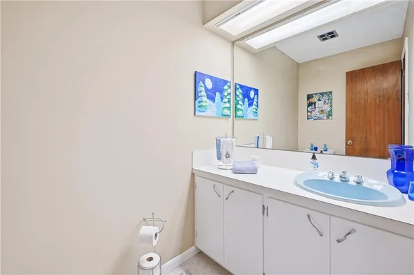 a bathroom with a sink mirror and toilet