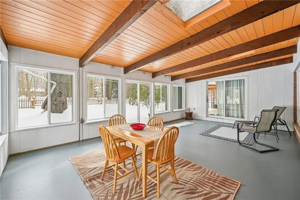 a dining room with furniture water view and wooden floor