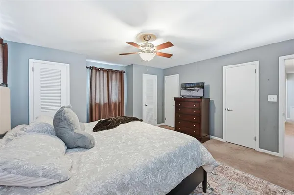 a bedroom with a bed dresser and a window