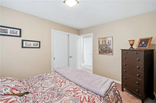 a bedroom with a bed and a dresser