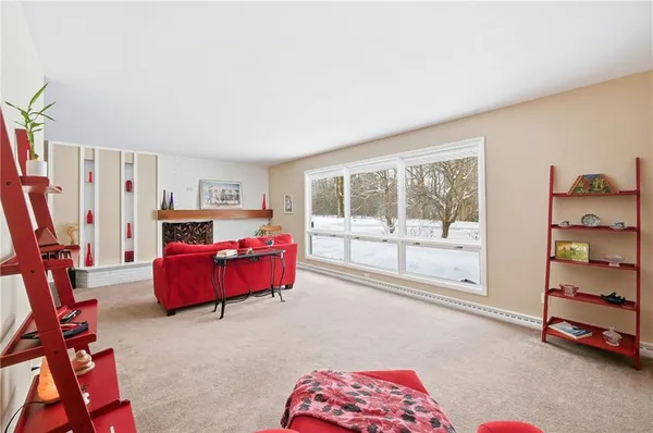 a bedroom with furniture and a large window