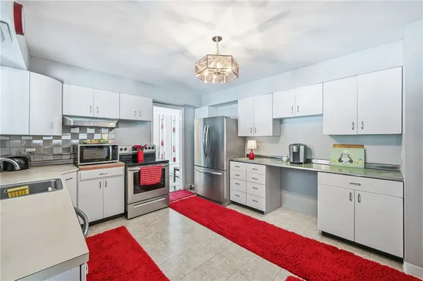 a kitchen with refrigerator cabinets and white appliances
