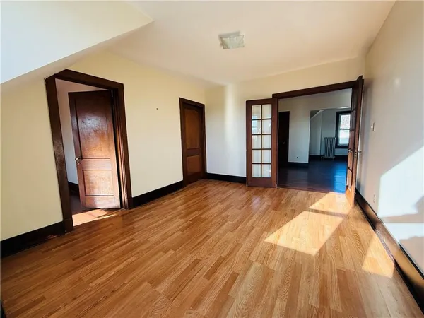 a view of a room with wooden floor and stairs