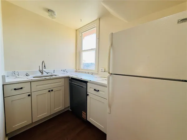 a spacious bathroom with a granite countertop sink and a window