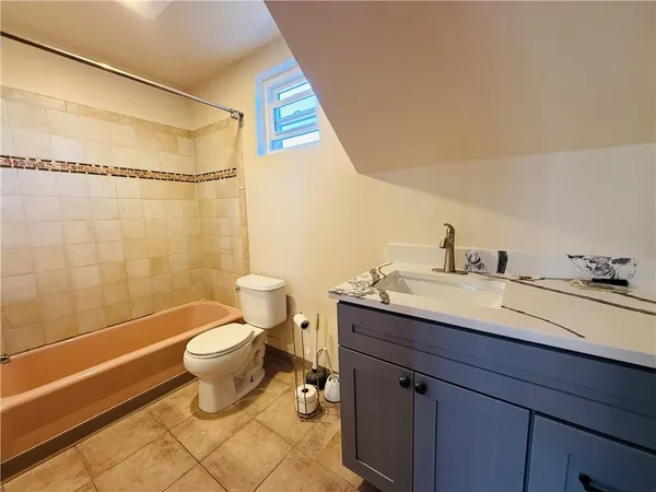 a bathroom with a sink mirror vanity and toilet