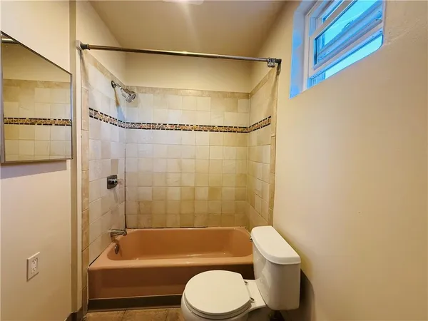 a bathroom with a toilet and a bathtub