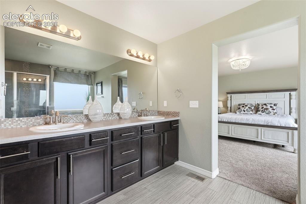 2264 Reed Grass Way Colorado Springs, CO 80915 - Photo 34 of 50 a spacious bathroom with a sink double vanity and a mirror