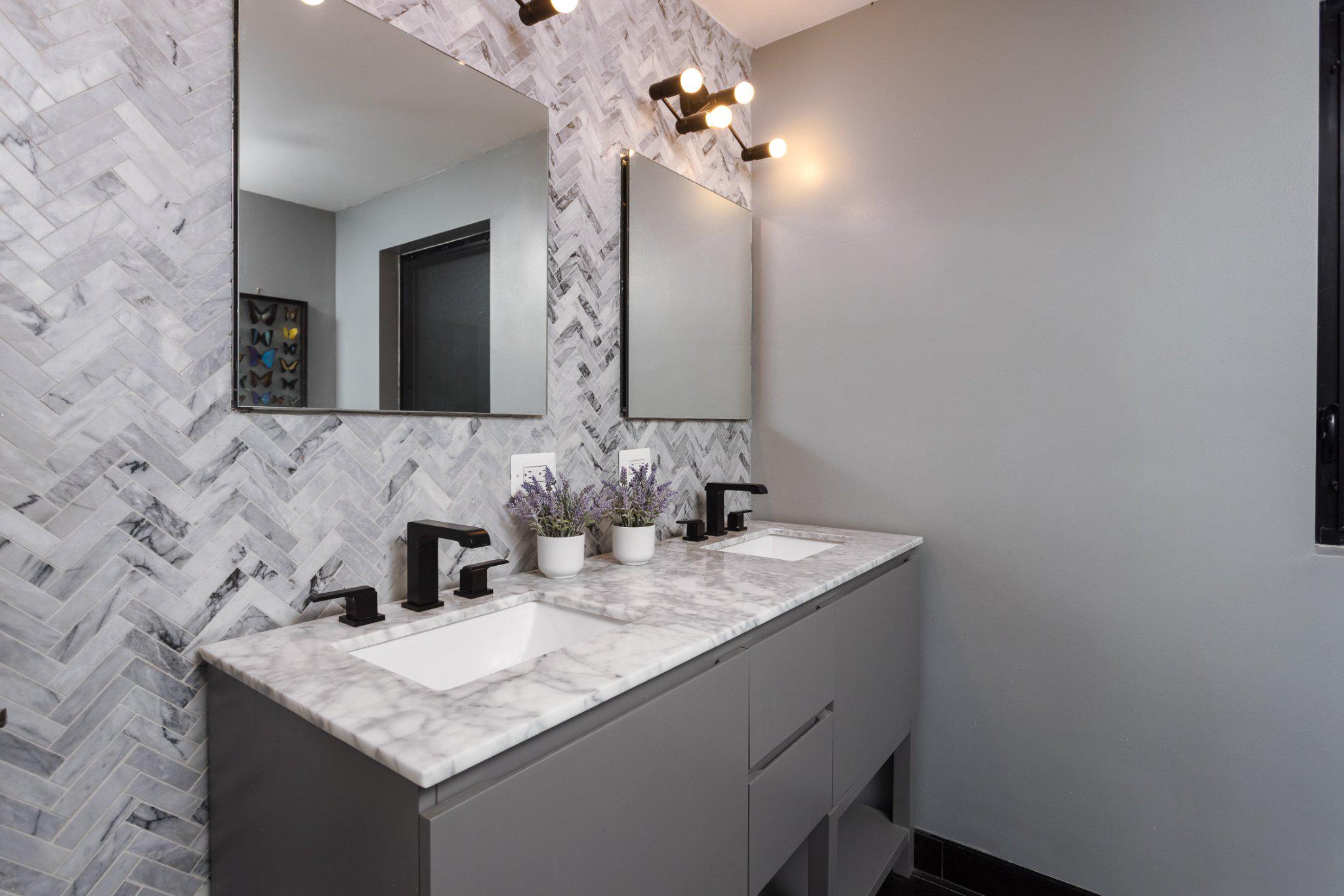 7006 Copeleigh Road Baltimore, MD 21212 - Photo 26 of 43 a bathroom with a granite countertop sink a mirror and shower