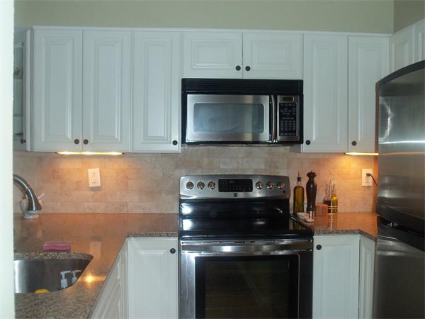 16 Canvasback Way, Unit 16 Walpole, MA 02081 - Photo 5 of 30 a kitchen with a stove and a microwave